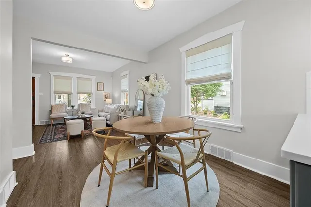 a view of a dining room with furniture and wooden floor