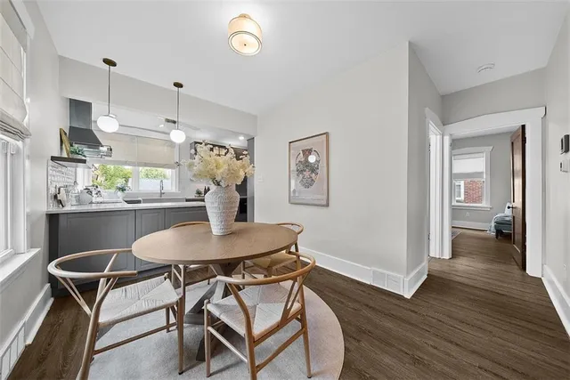 a dining room with furniture and wooden floor