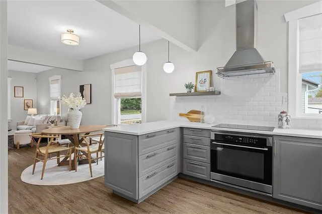 a kitchen with a sink stove and cabinets