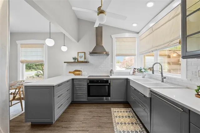 a view of a room with wooden floor and furniture
