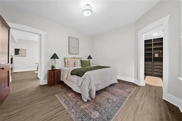 a bedroom with a bed and a mirror