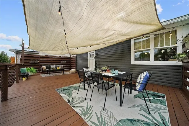 a view of a white house with a yard and garage