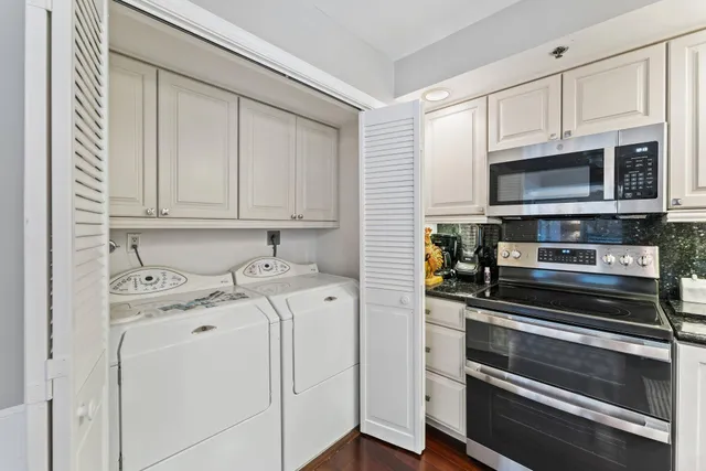 a bedroom with a bed and a lamp on dresser