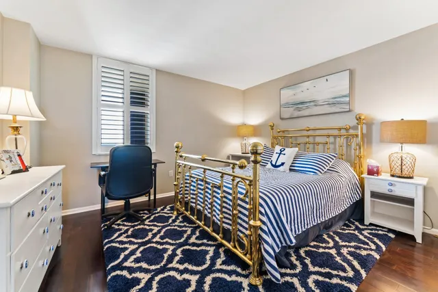 a bedroom with a large bed and a window