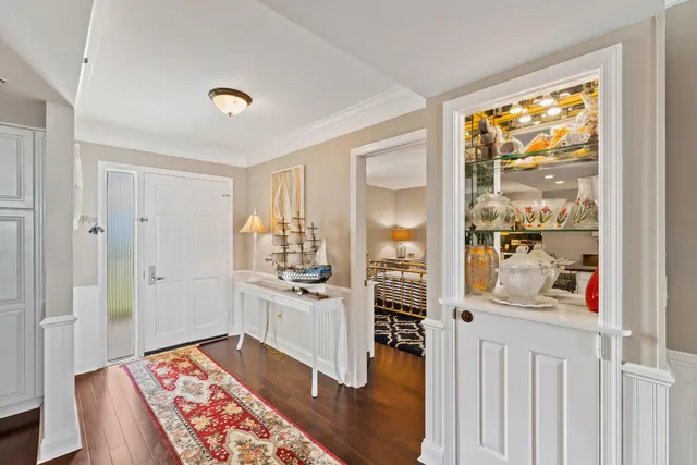 a living room with furniture a flat screen tv and a floor to ceiling window
