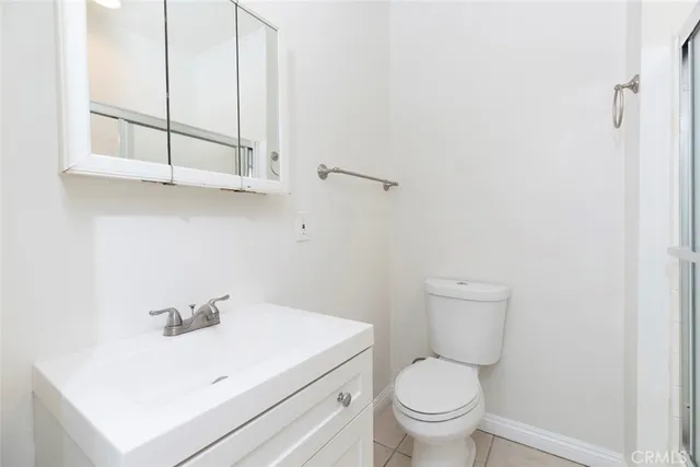 a white toilet sitting next to a bathroom sink