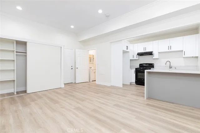 an empty room with kitchen appliances and cabinets
