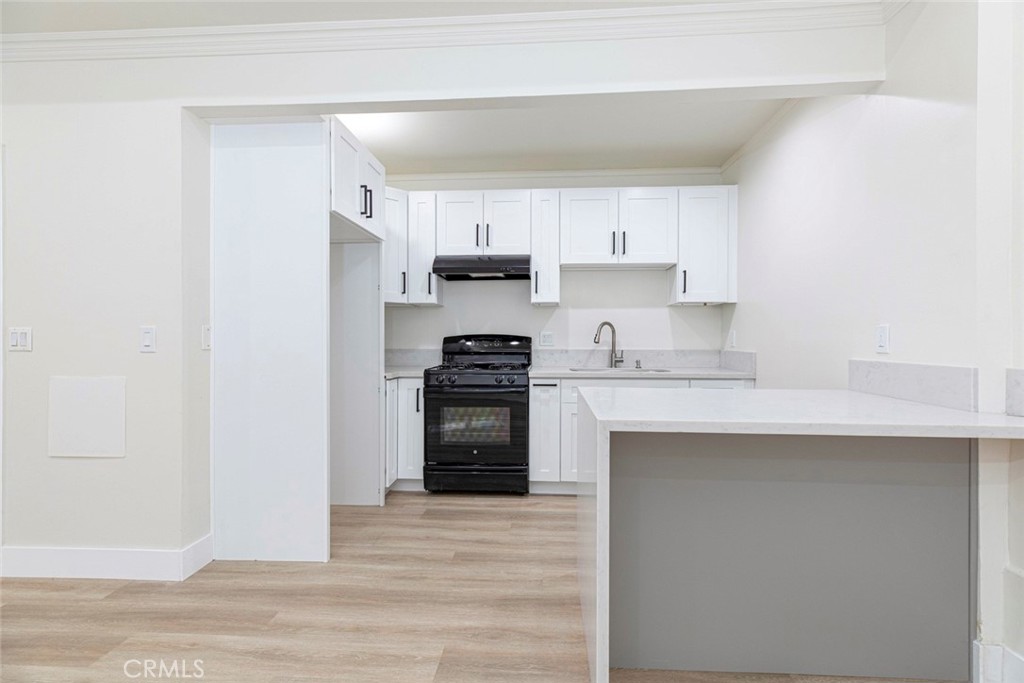 14319 Tiara Street, Unit 2 Van Nuys, CA 91401 - Photo 7 of 14 a kitchen with granite countertop a refrigerator stove top oven and sink