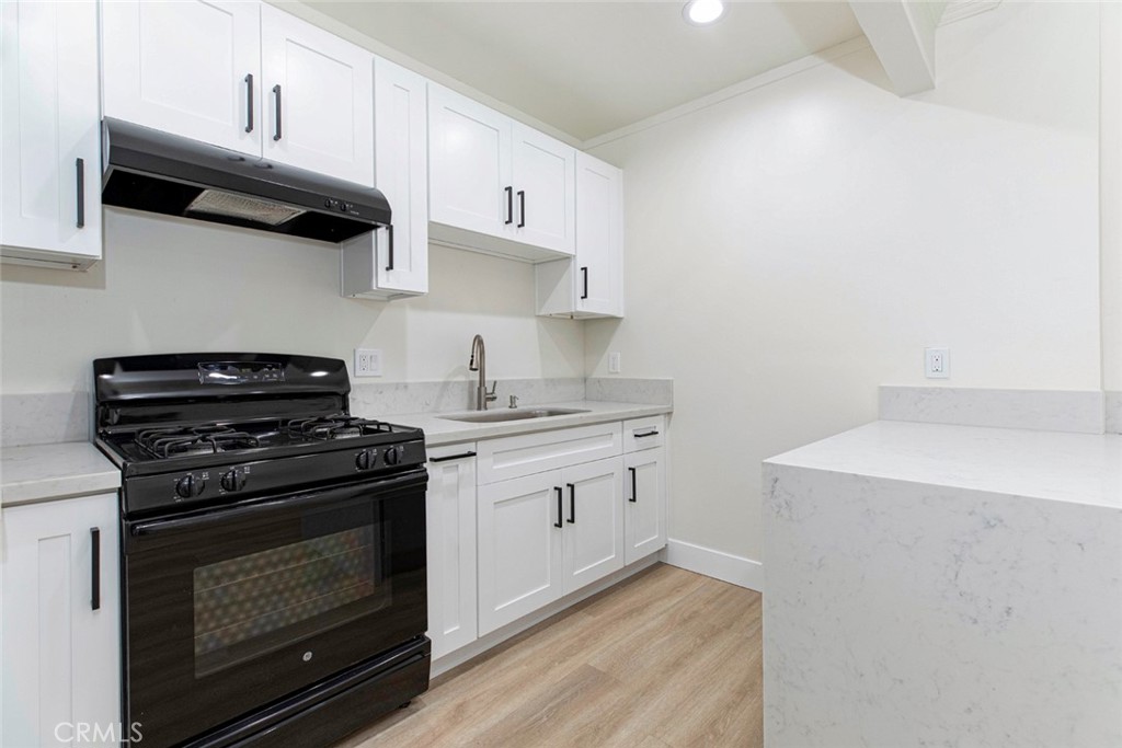 14319 Tiara Street, Unit 2 Van Nuys, CA 91401 - Photo 8 of 14 a kitchen with a stove and a microwave