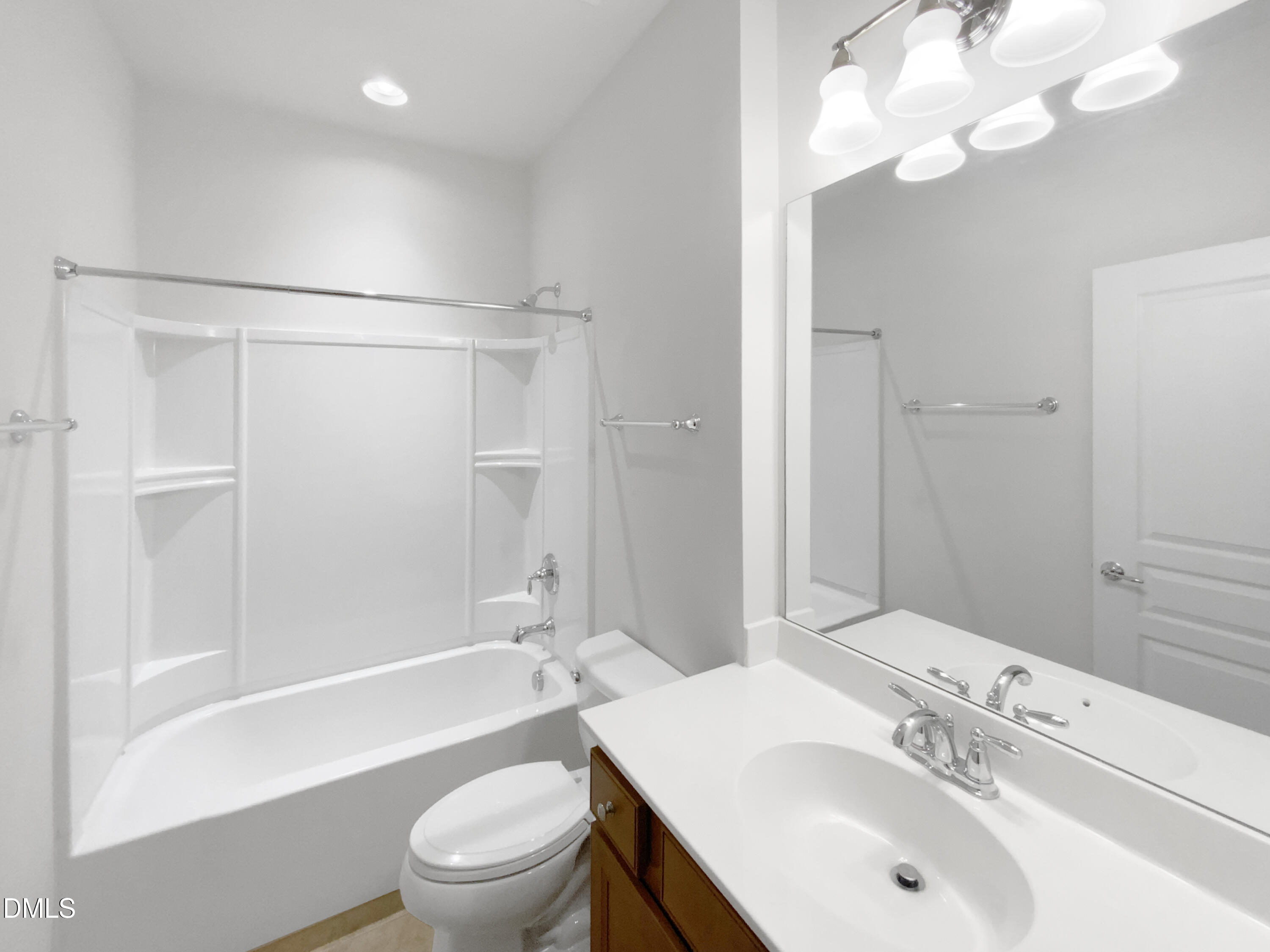 540 Tomkins Loop Cary, NC 27519 - Photo 14 of 19 a bathroom with a sink a toilet and a large mirror