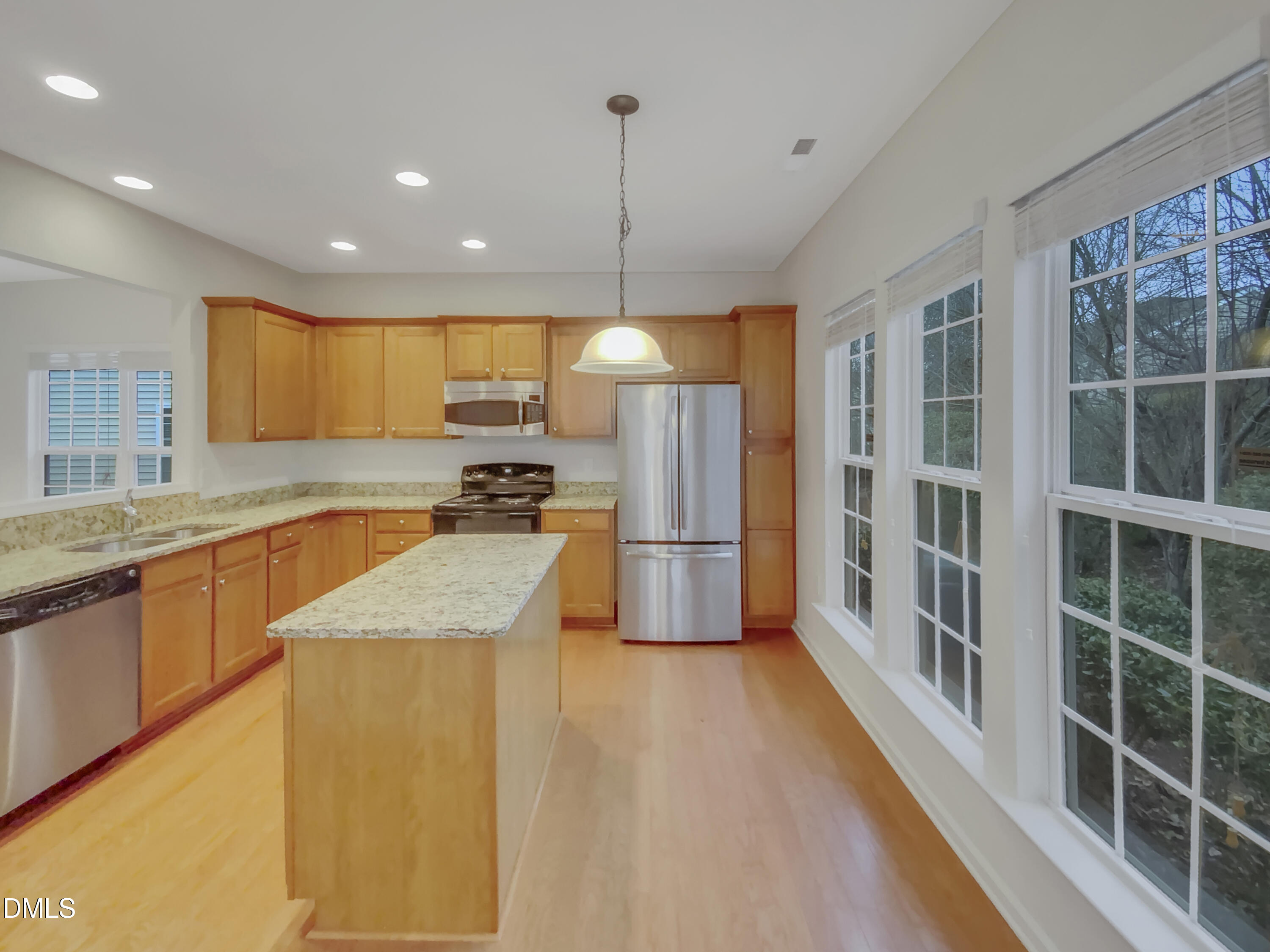 540 Tomkins Loop Cary, NC 27519 - Photo 5 of 19 a kitchen with stainless steel appliances granite countertop a refrigerator a sink dishwasher a oven and a dining table with wooden floor