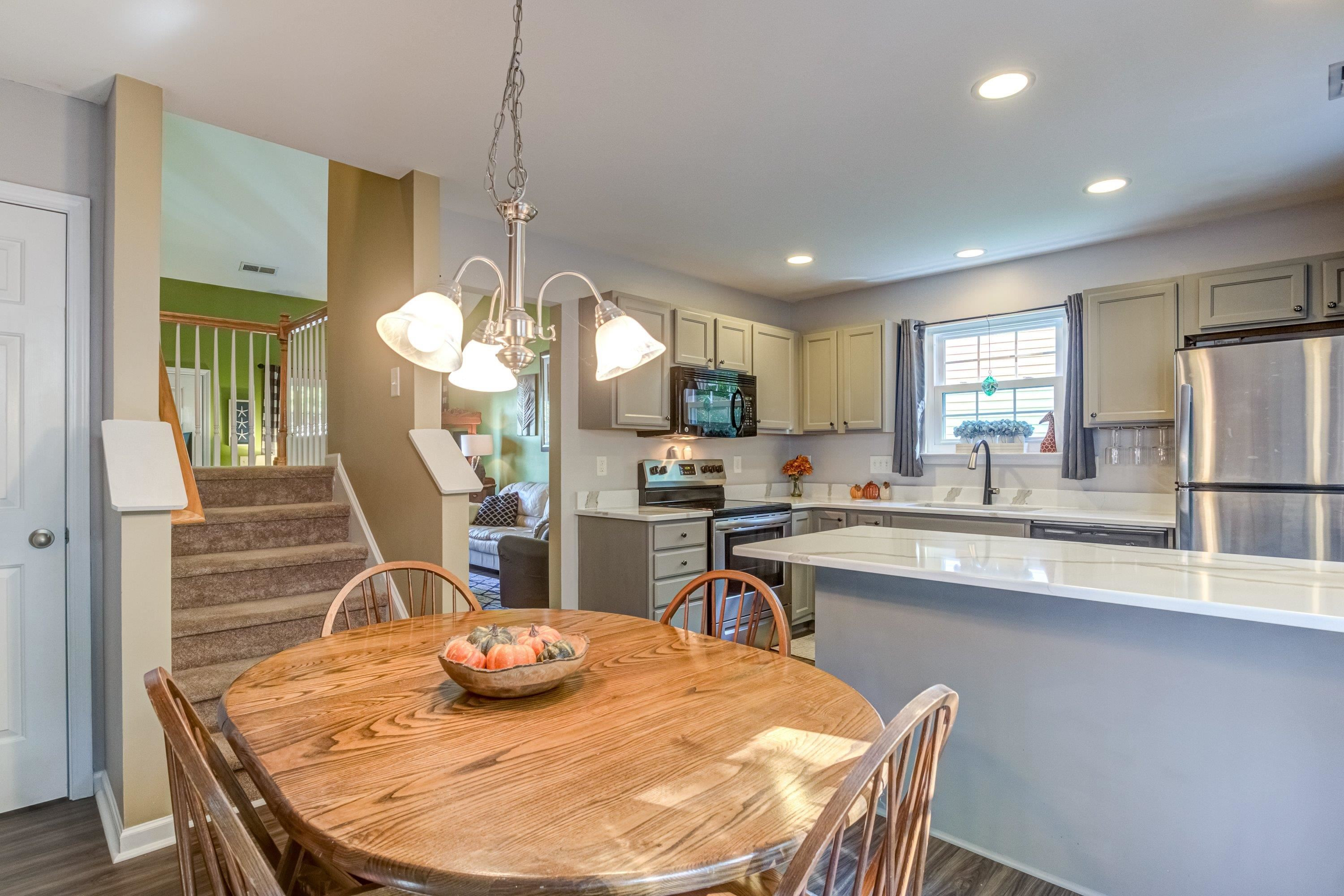 7726 Averette Field Drive Raleigh, NC 27616 - Photo 14 of 29 a kitchen with stainless steel appliances granite countertop a sink a stove a dining table and chairs