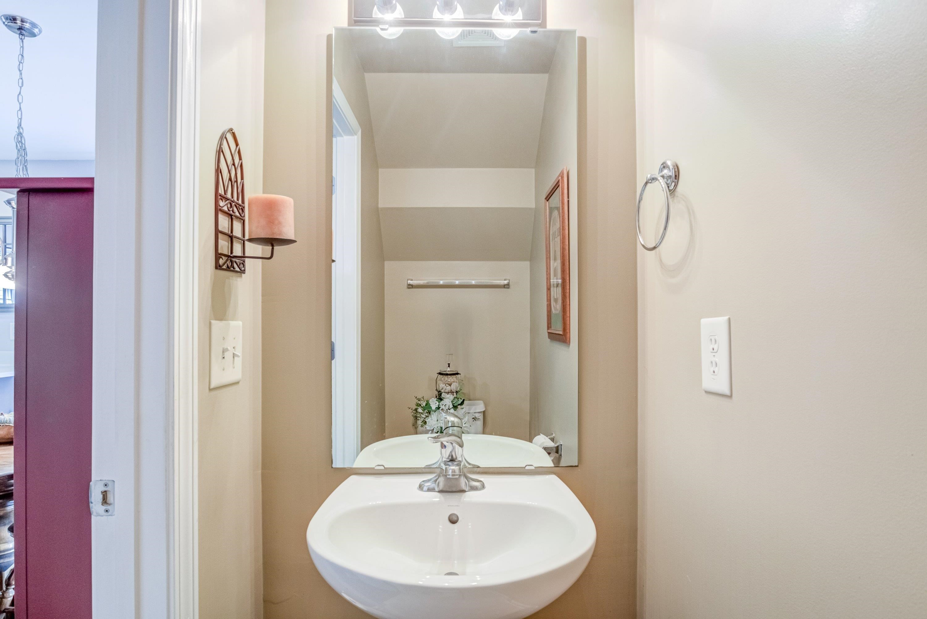 7726 Averette Field Drive Raleigh, NC 27616 - Photo 16 of 29 a bathroom with a sink and a mirror