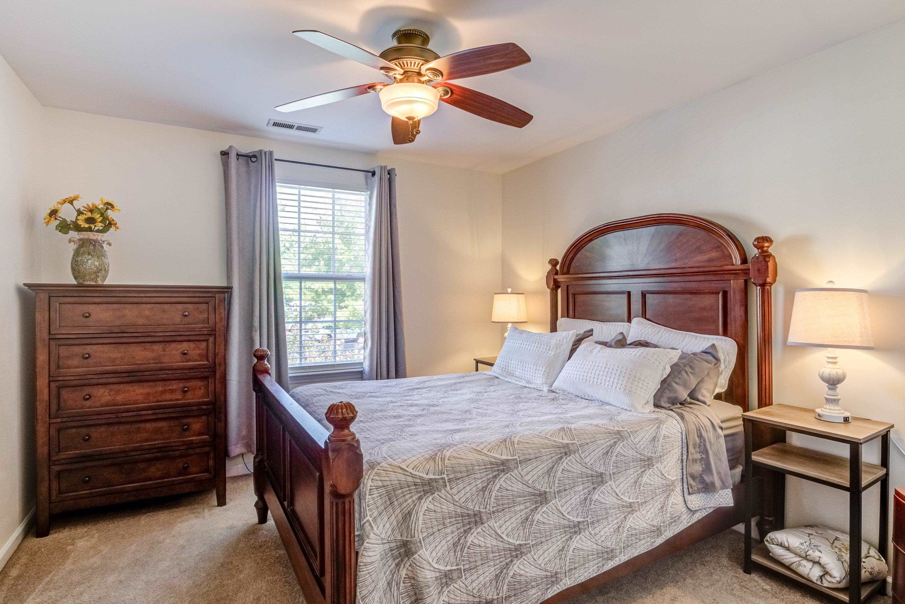 7726 Averette Field Drive Raleigh, NC 27616 - Photo 17 of 29 a bedroom with a bed and a chandelier