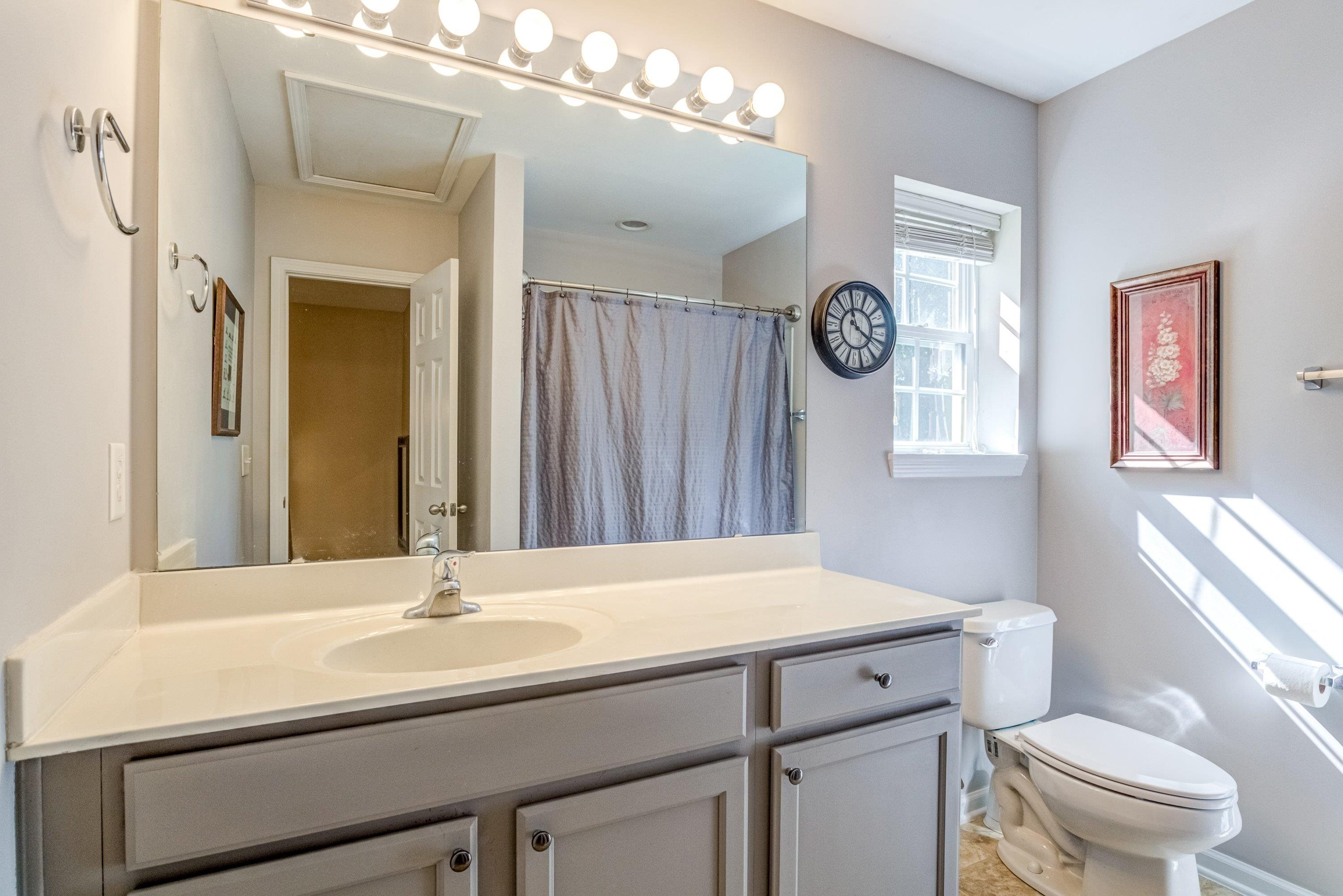 7726 Averette Field Drive Raleigh, NC 27616 - Photo 19 of 29 a bathroom with a sink a toilet and a mirror