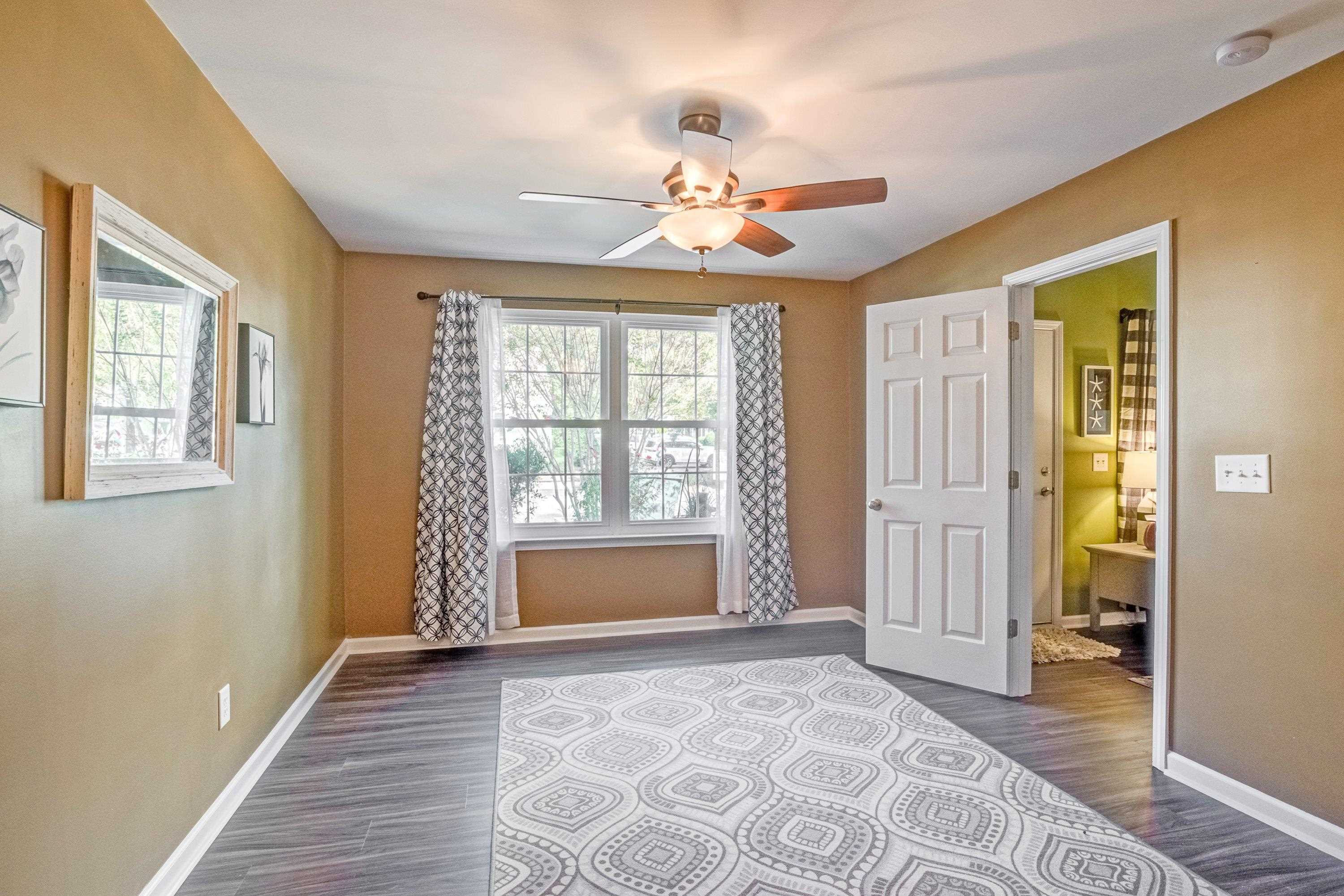7726 Averette Field Drive Raleigh, NC 27616 - Photo 23 of 29 a view of an empty room with wooden floor and a window