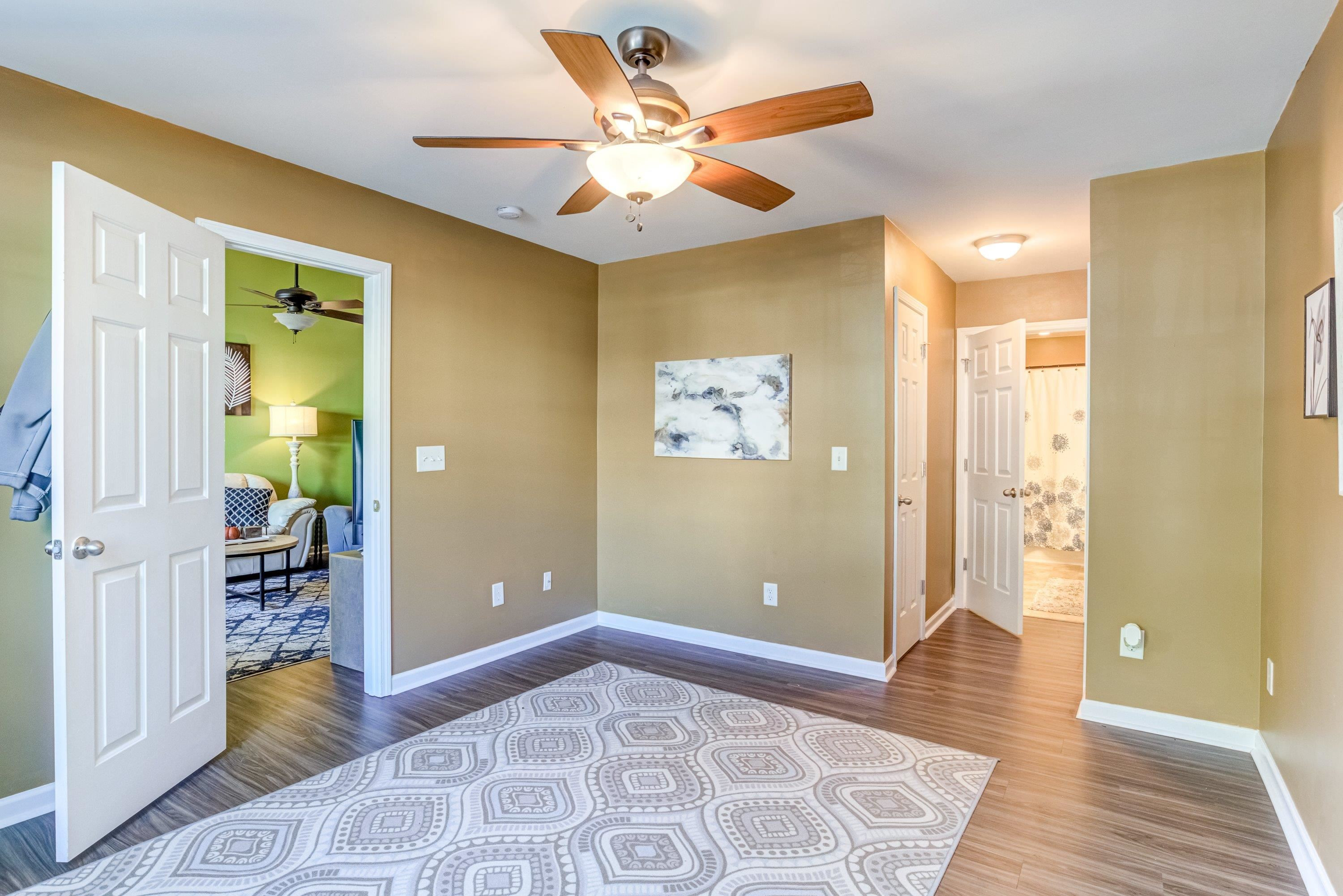 7726 Averette Field Drive Raleigh, NC 27616 - Photo 24 of 29 a bedroom with a bed and a chandelier