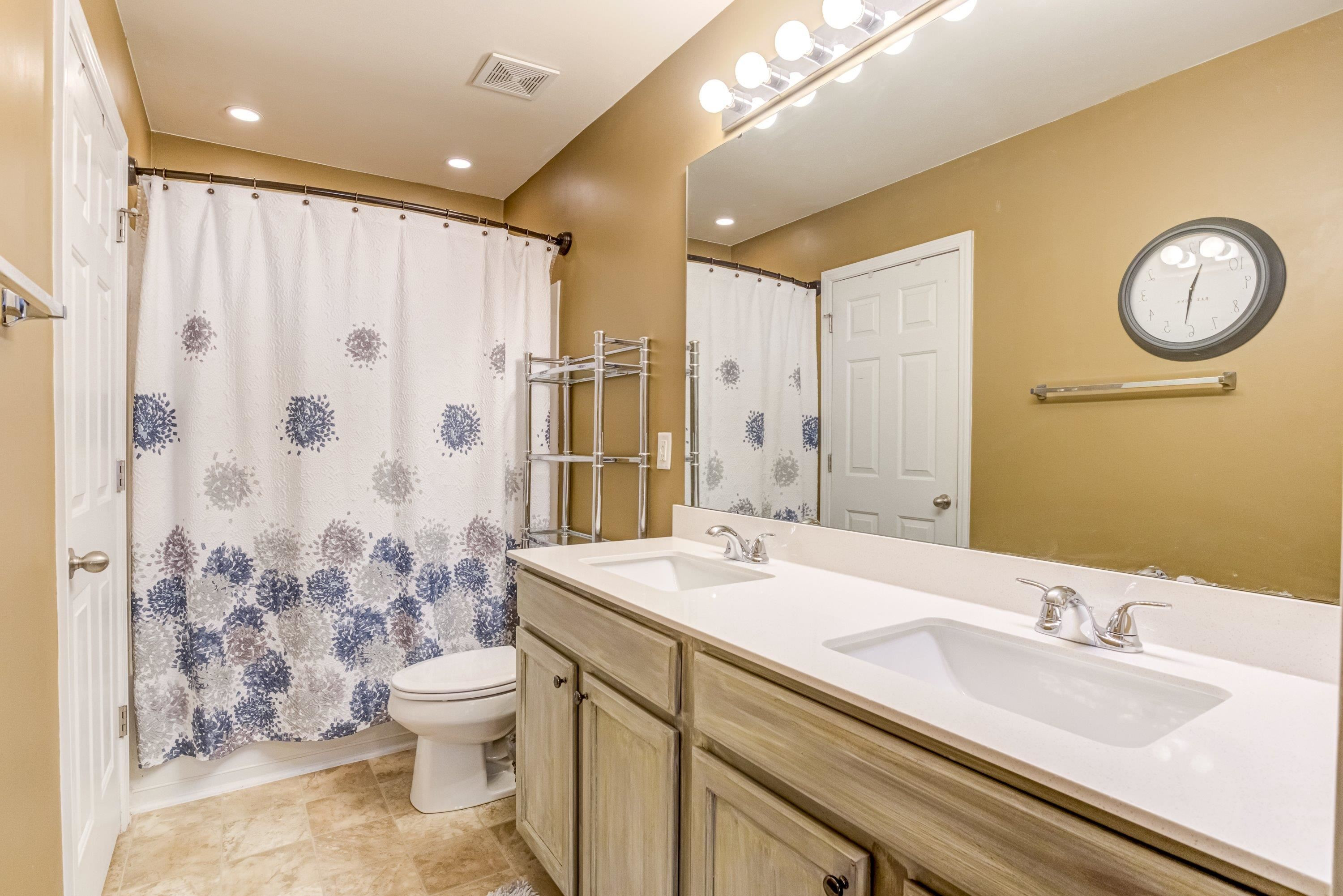 7726 Averette Field Drive Raleigh, NC 27616 - Photo 25 of 29 a bathroom with a double vanity sink toilet mirror and shower