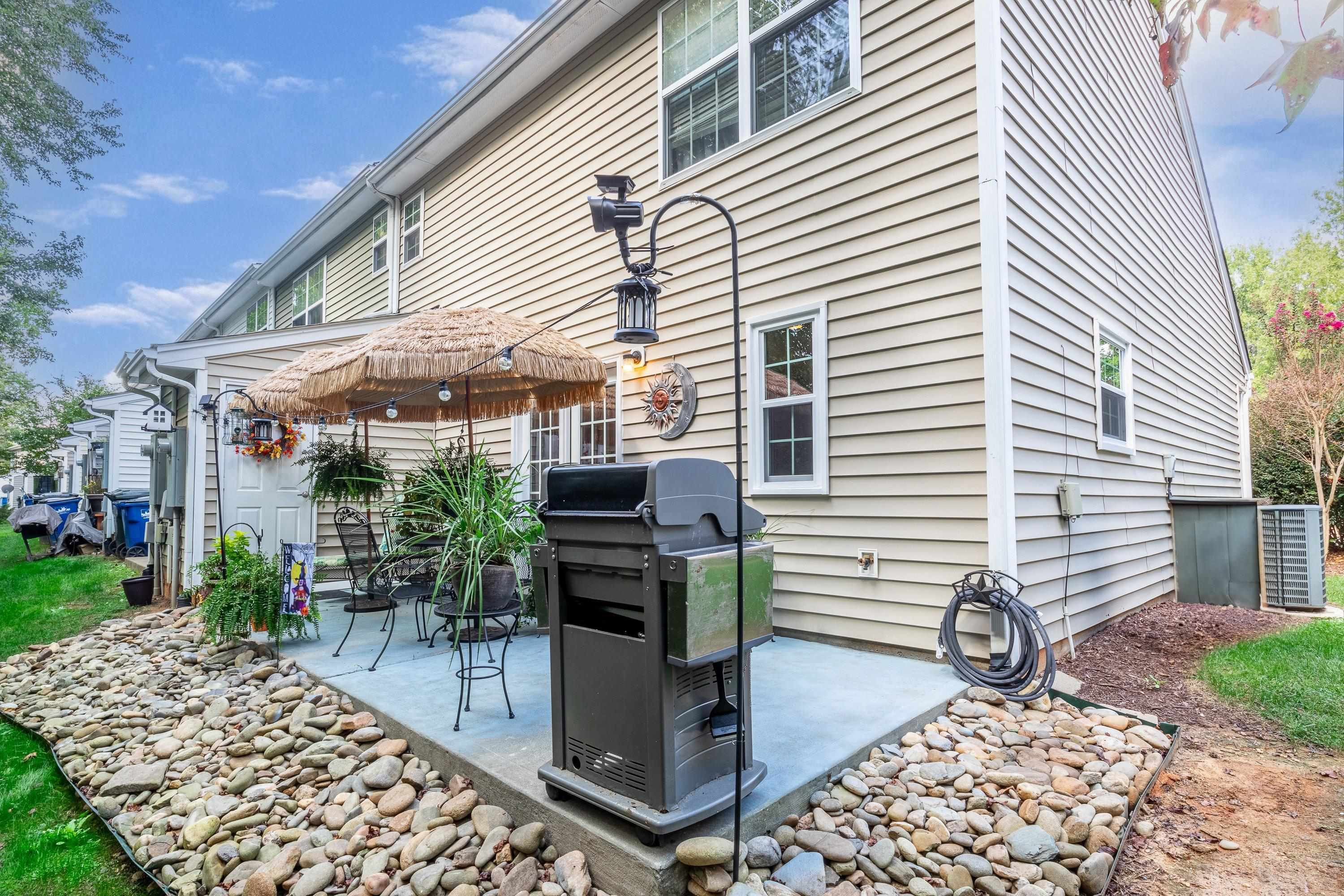 7726 Averette Field Drive Raleigh, NC 27616 - Photo 28 of 29 a patio with table and chairs and potted plants
