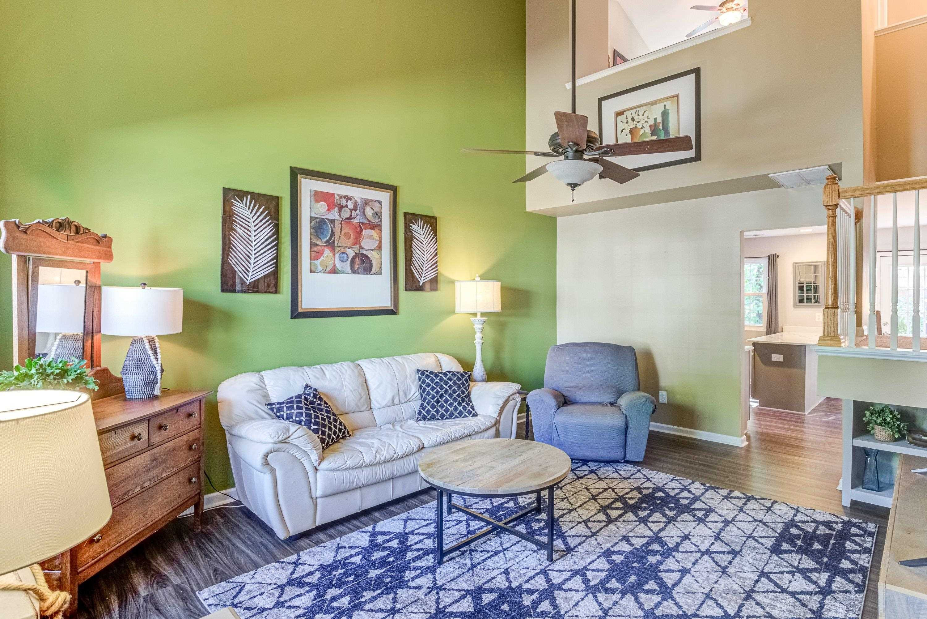7726 Averette Field Drive Raleigh, NC 27616 - Photo 3 of 29 a living room with furniture and wooden floor