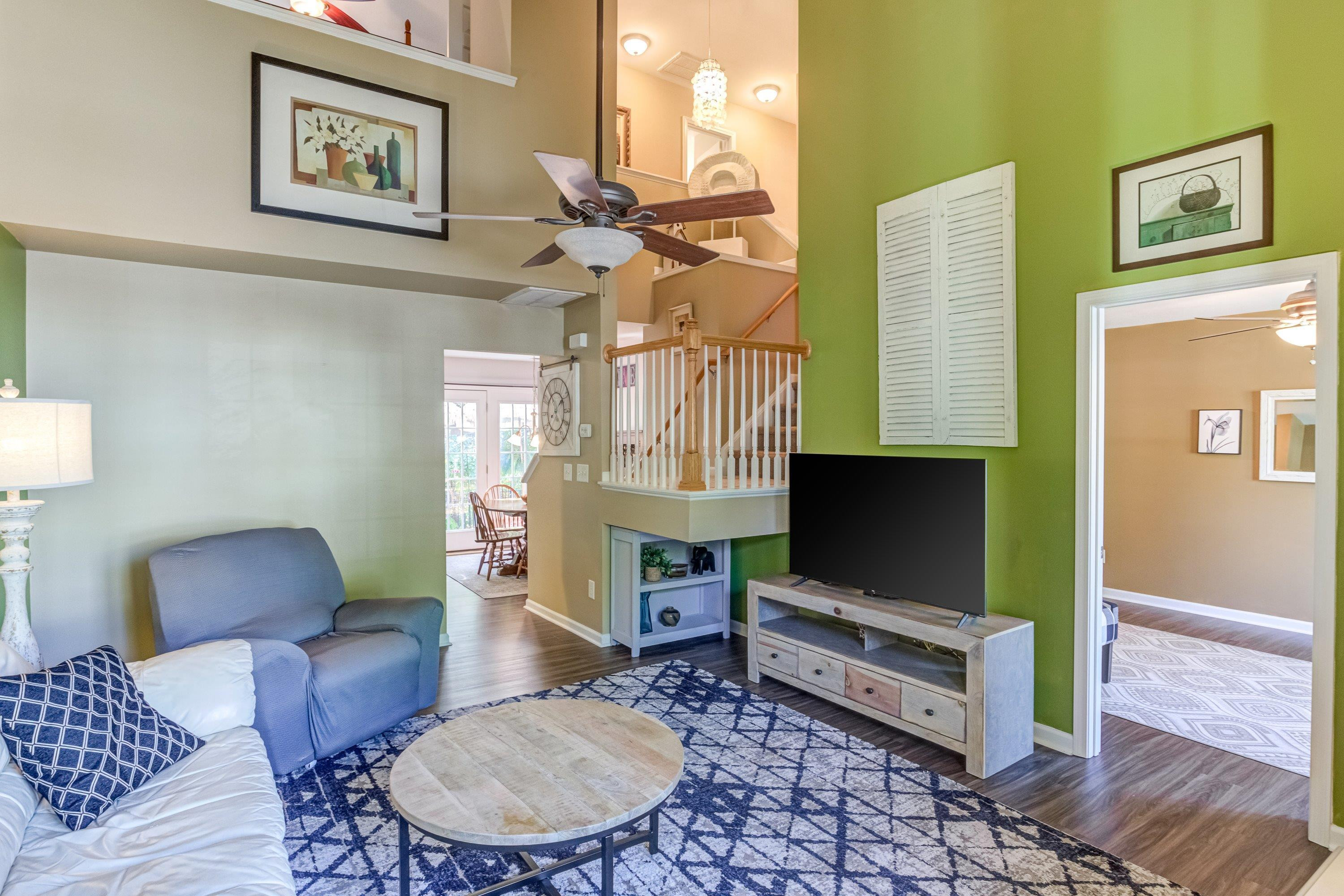 7726 Averette Field Drive Raleigh, NC 27616 - Photo 4 of 29 a living room with furniture a flat screen tv and a fireplace