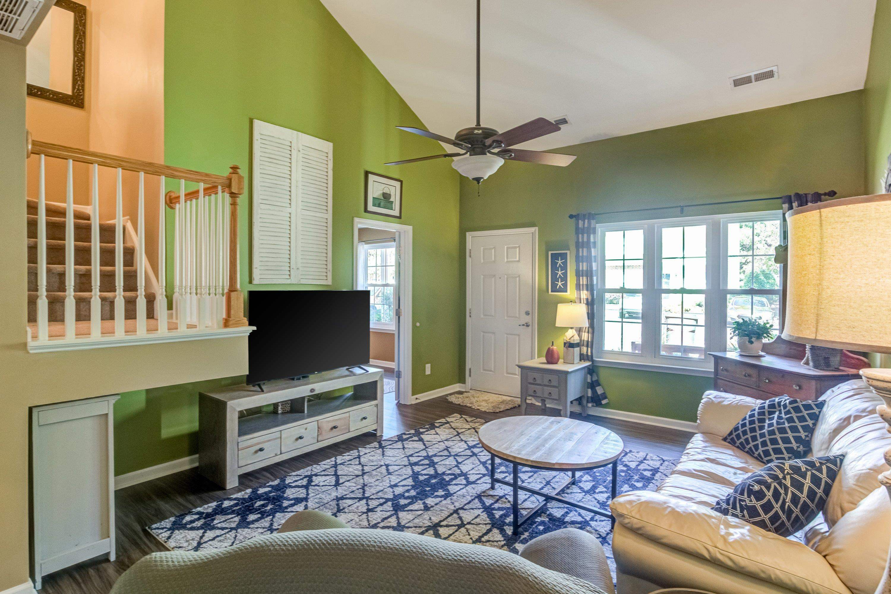 7726 Averette Field Drive Raleigh, NC 27616 - Photo 5 of 29 a living room with furniture a fireplace and a flat screen tv