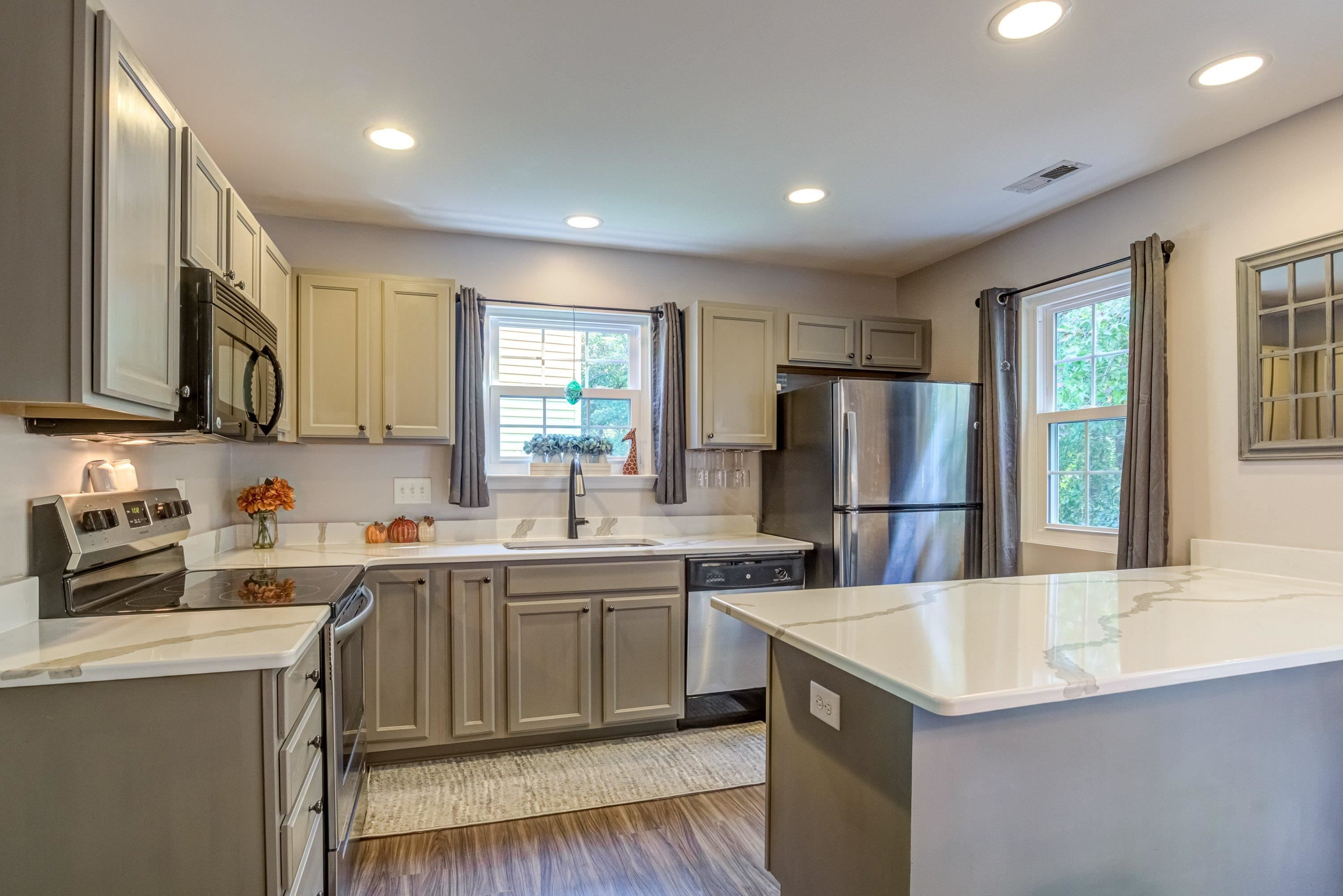 7726 Averette Field Drive Raleigh, NC 27616 - Photo 8 of 29 a kitchen with sink a refrigerator and cabinets