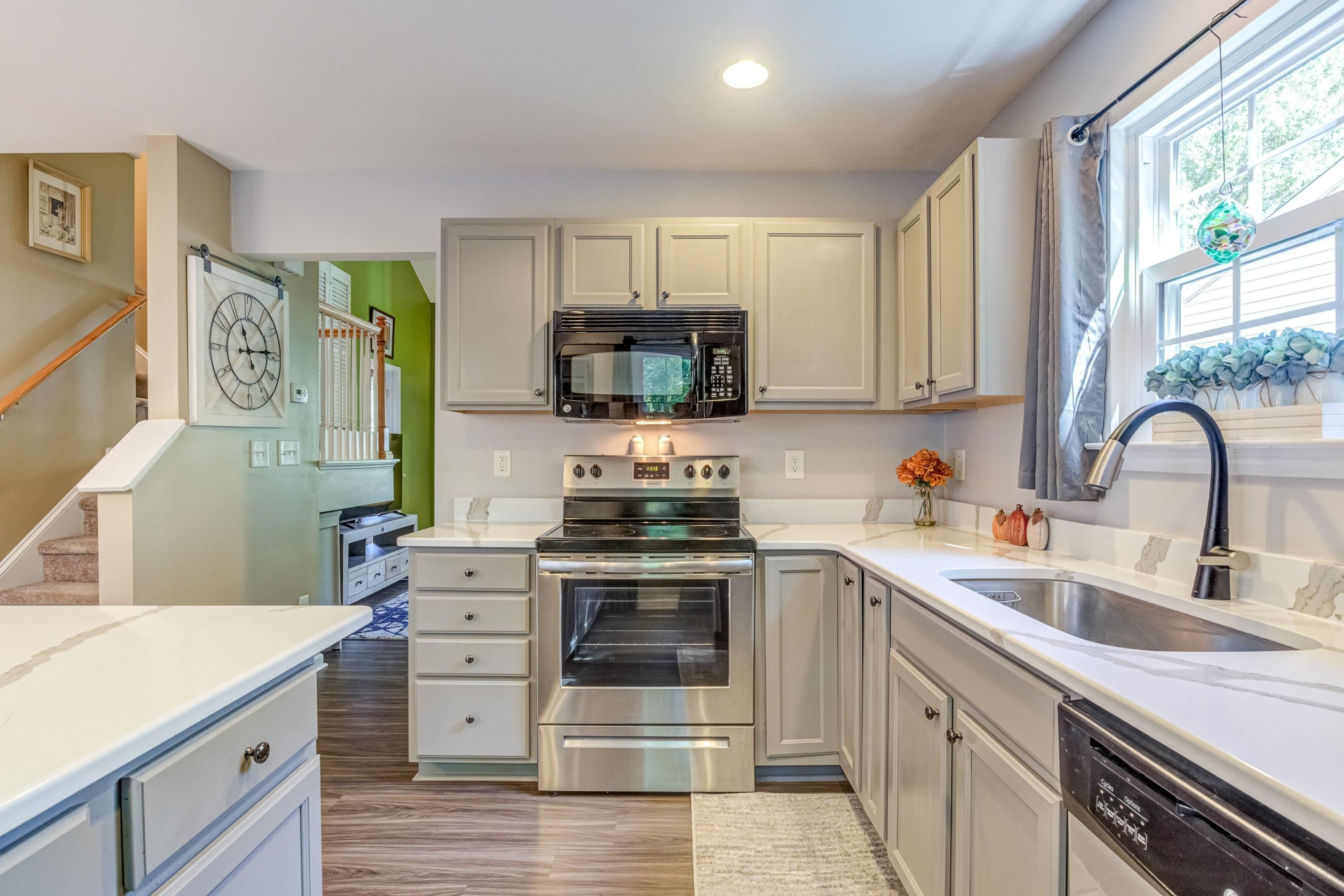 7726 Averette Field Drive Raleigh, NC 27616 - Photo 10 of 29 a kitchen with stainless steel appliances granite countertop a stove and a sink