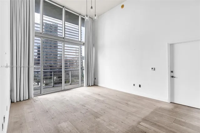 a view of empty room with floor to ceiling window