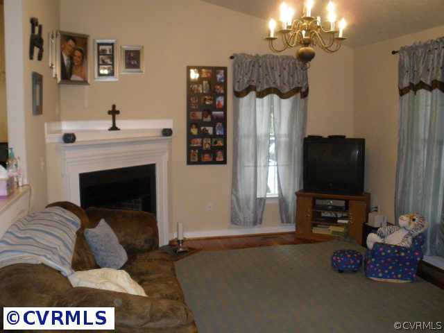 Other - Living room with corner fireplace and hard
