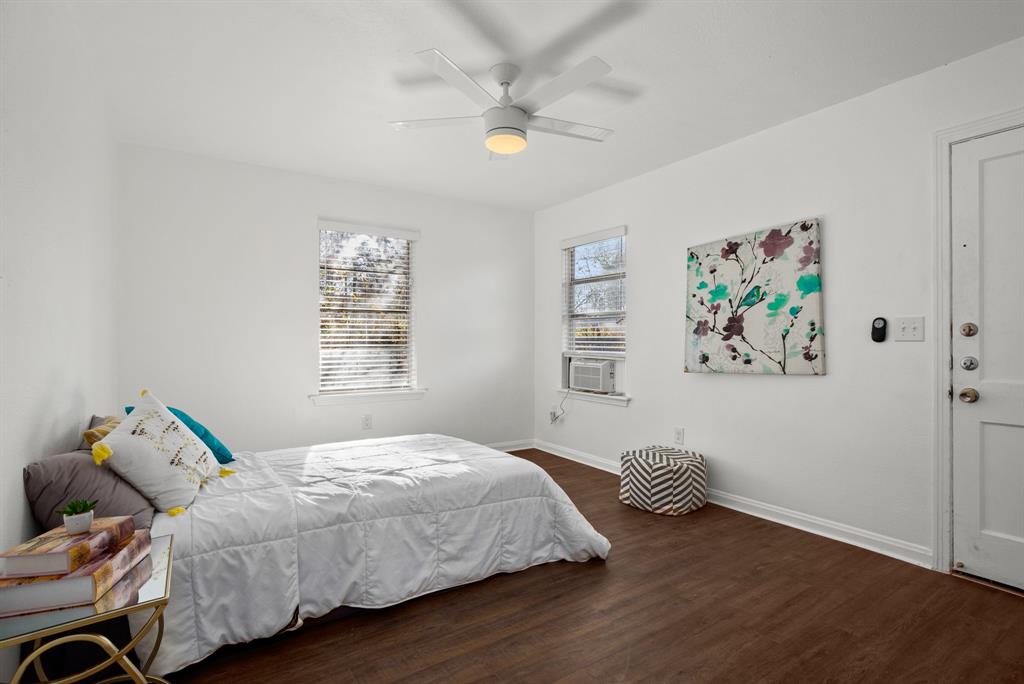 301 East 33rd Street, Unit 4 Austin, TX 78705 - Photo 7 of 10 Bedroom featuring dark wood-type flooring, a ceiling fan, and cooling unit