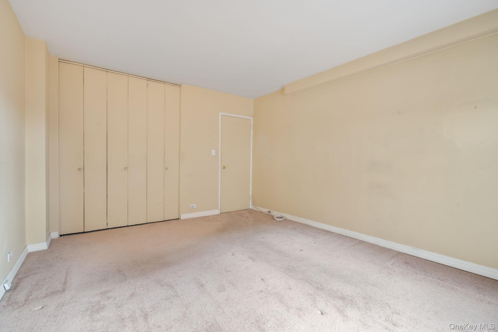61-15 97th Street, Unit 12H Queens, NY 11374 - Photo 11 of 23 Unfurnished bedroom with carpet and a closet