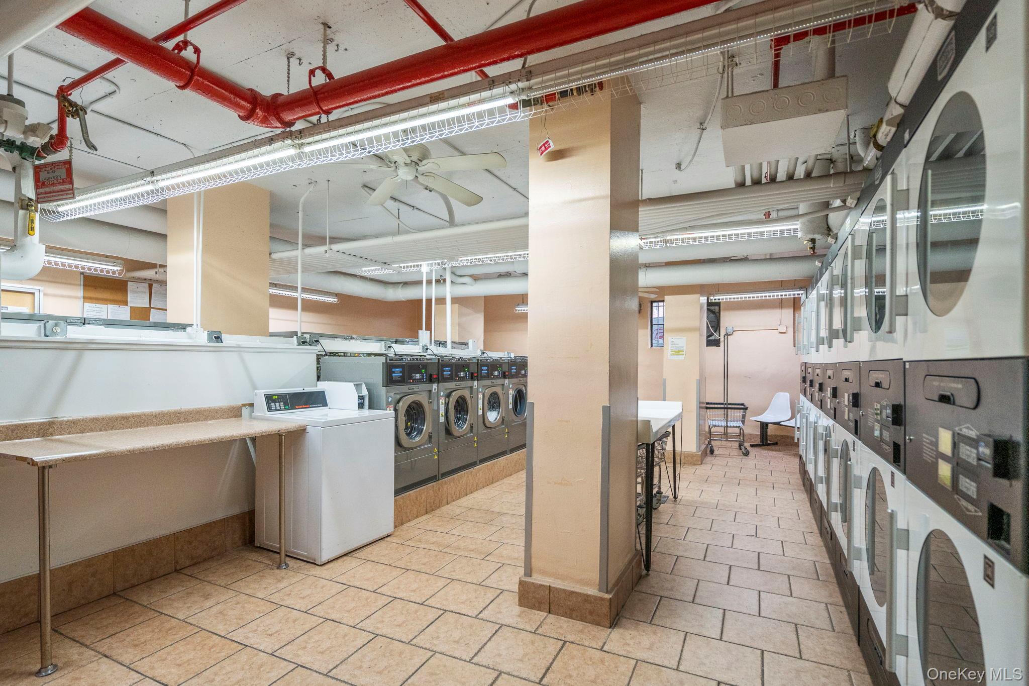 61-15 97th Street, Unit 12H Queens, NY 11374 - Photo 18 of 23 Shared laundry with separate washer and dryer, ceiling fan, and light tile patterned flooring