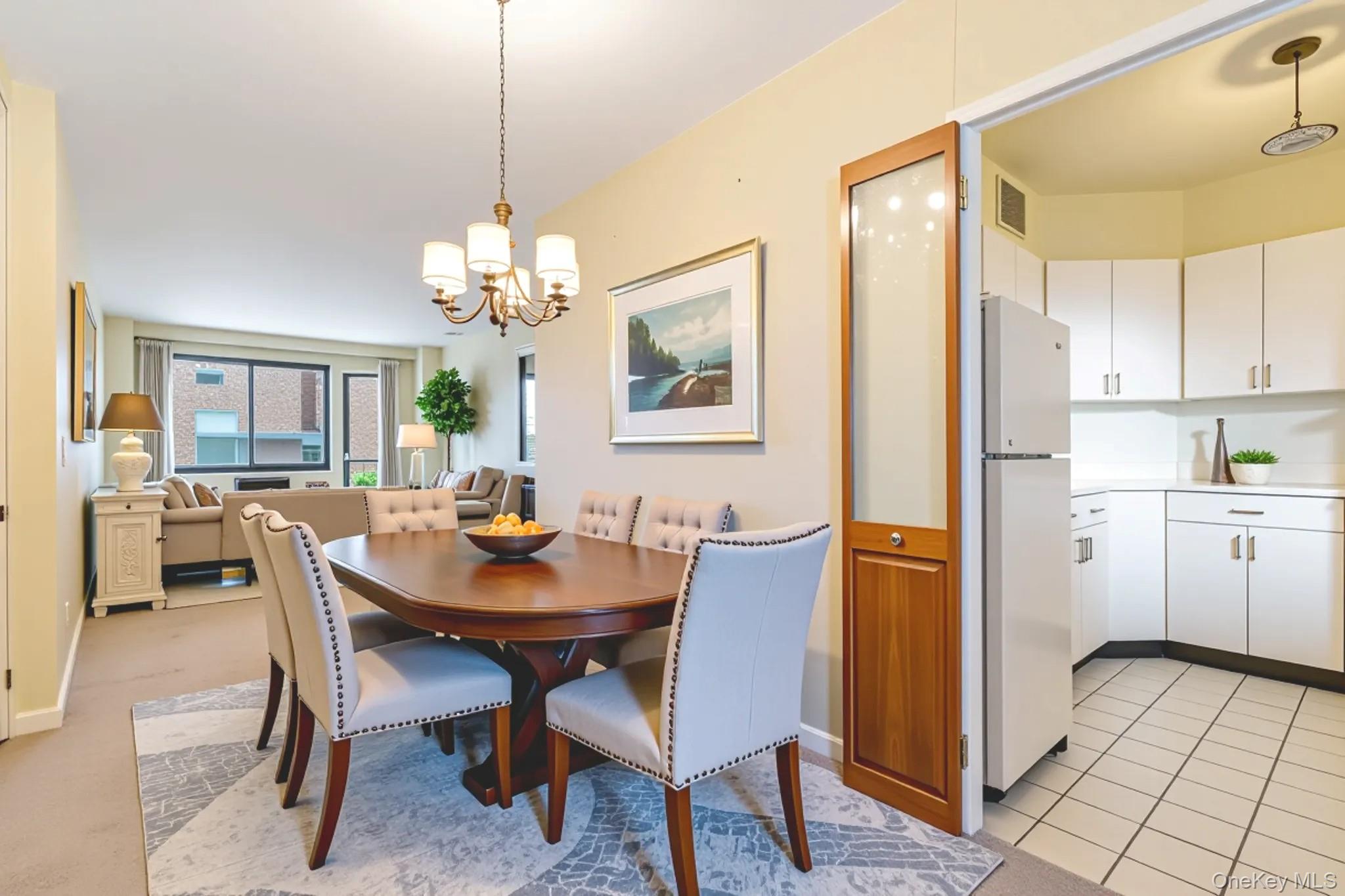 61-15 97th Street, Unit 12H Queens, NY 11374 - Photo 5 of 23 Dining room with a chandelier and baseboards