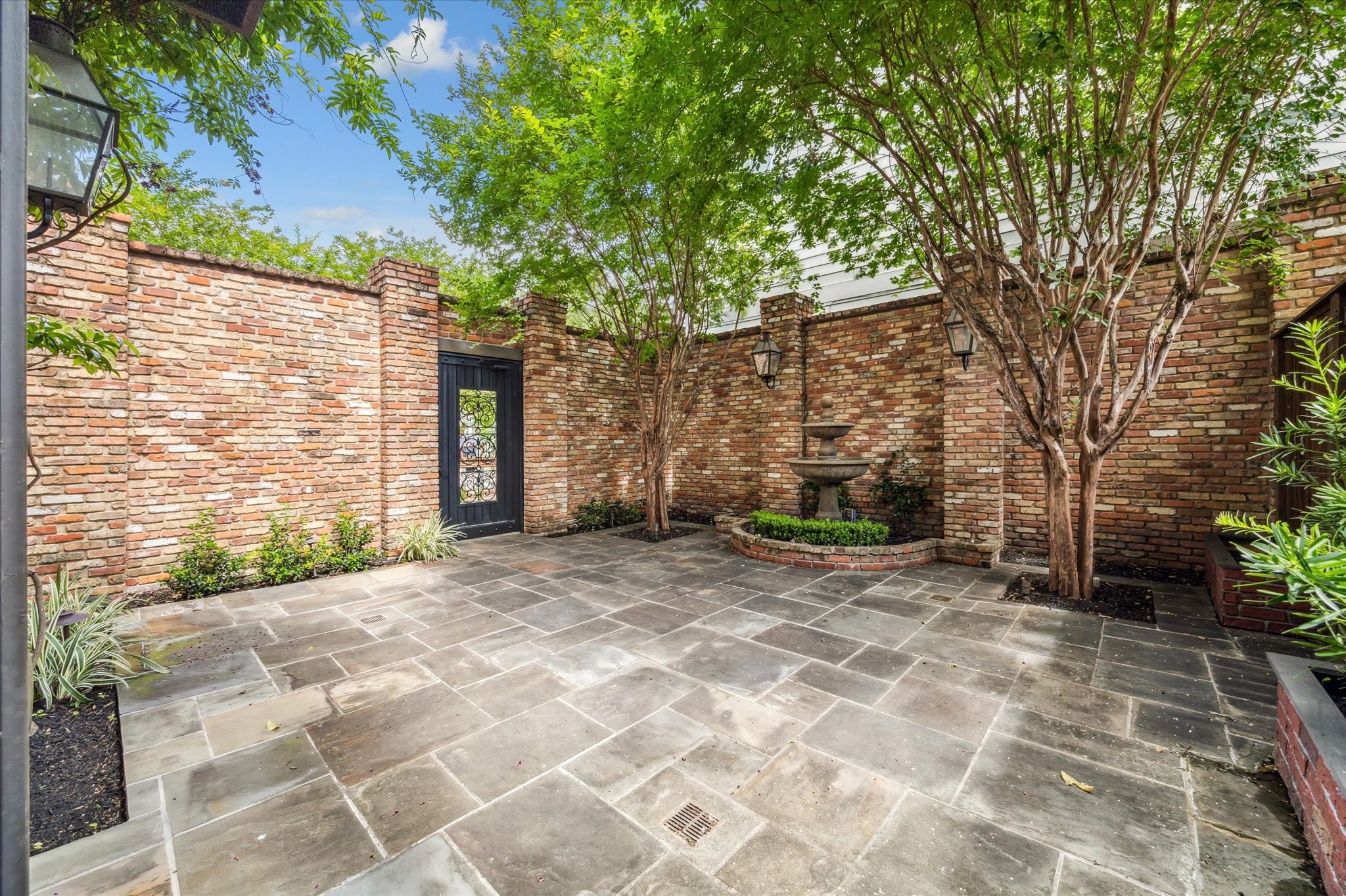 808 Coronado Street Houston, TX 77009 - Photo 14 of 50 Unit 1, Private patio with brick walls, stone pavers, and tree canopy.