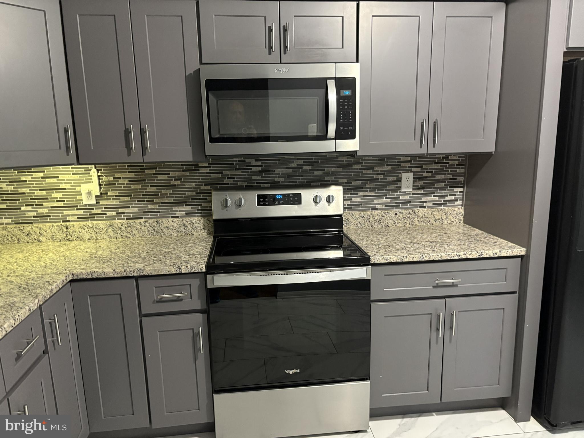 13242 Stravinsky Terrace Silver Spring, MD 20904 - Photo 3 of 11 a kitchen with granite countertop cabinets stainless steel appliances and a sink