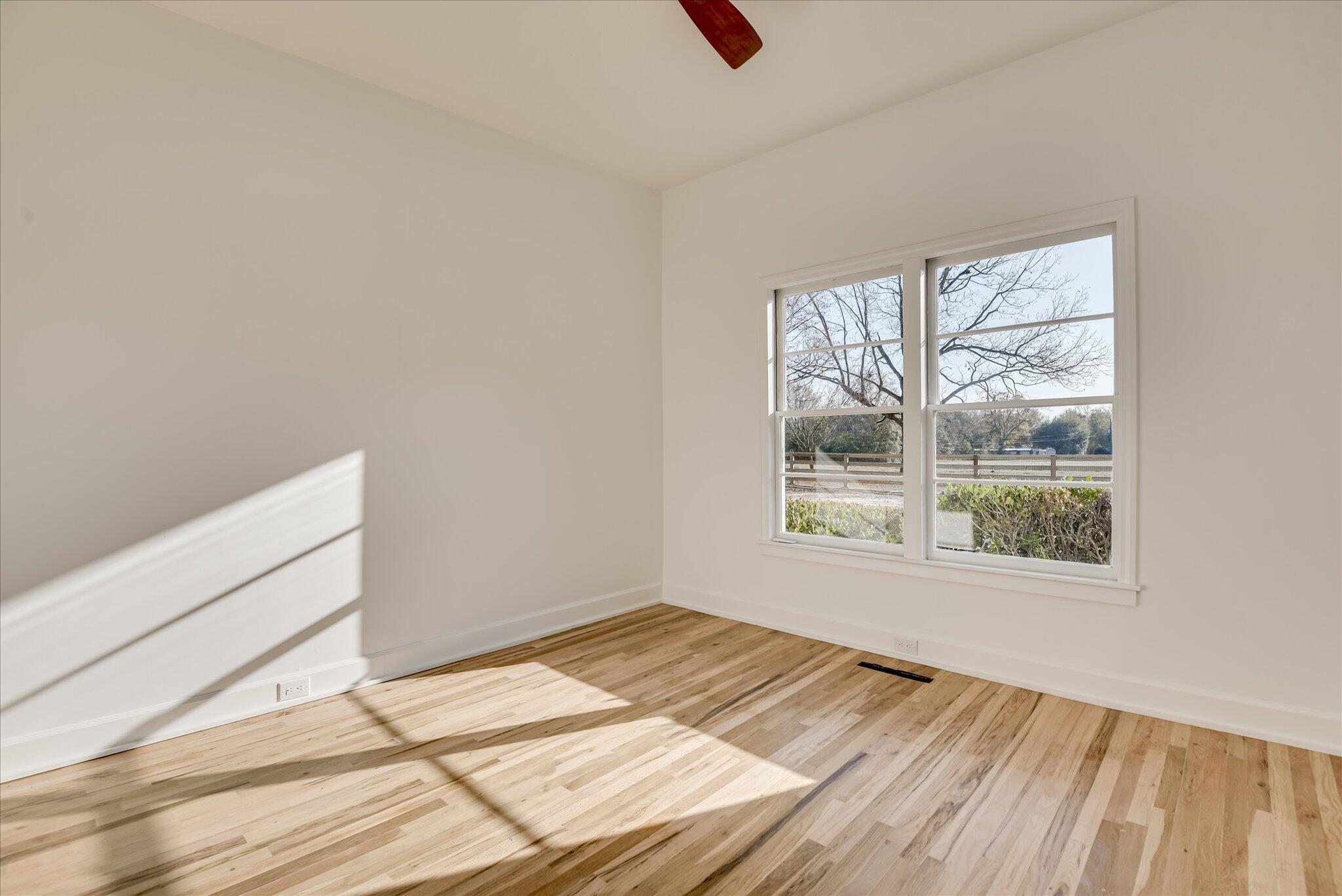 126 Mosley Road Aiken, SC 29801 - Photo 24 of 29 a view of an empty room with wooden floor and a window