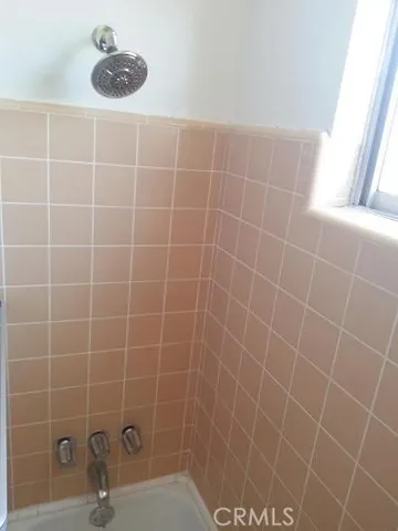a bathroom with a sink mirror and shower