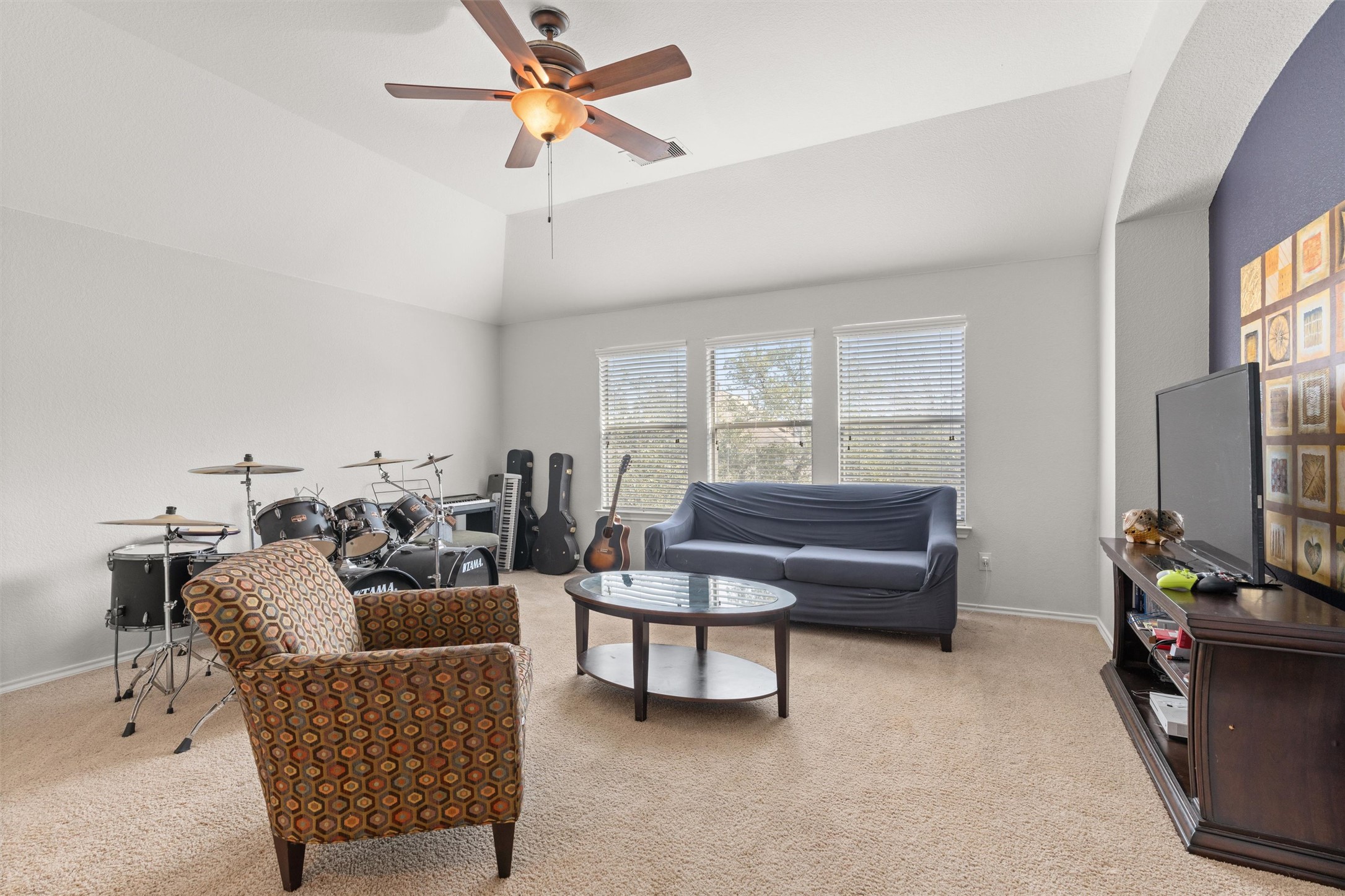 400 Red Hawk Drive Leander, TX 78641 - Photo 20 of 36 Living area with a ceiling fan, light colored carpet, and lofted ceiling