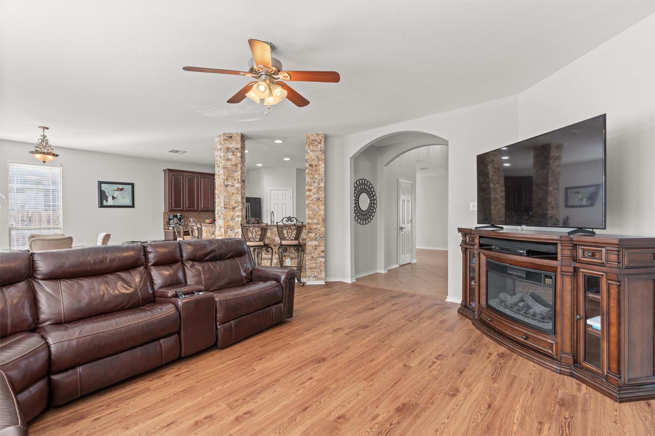 400 Red Hawk Drive Leander, TX 78641 - Photo 7 of 36 Living area with arched walkways, light wood finished floors, and a ceiling fan