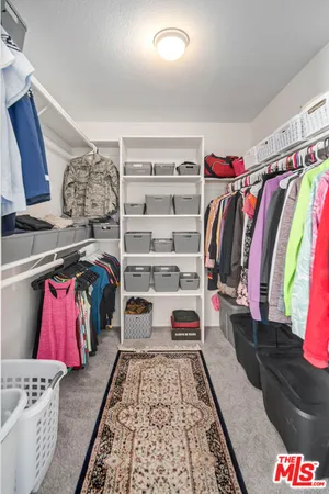 a view of a livingroom with workspace and a window