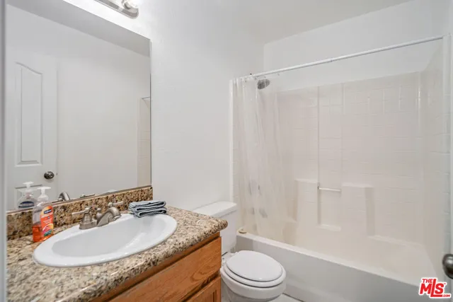 a bedroom with furniture and a large window