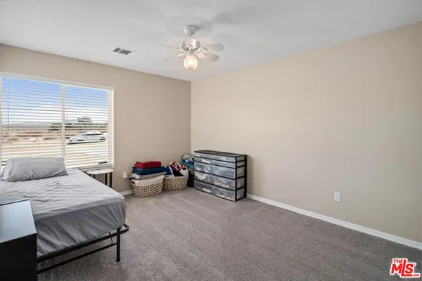 a bedroom with bed and a chandelier