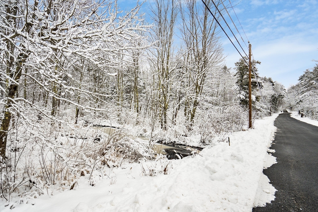 750 Teel Road Winchendon, MA 01475 - Photo 30 of 41 a view of a dry yard covered with snow in the background