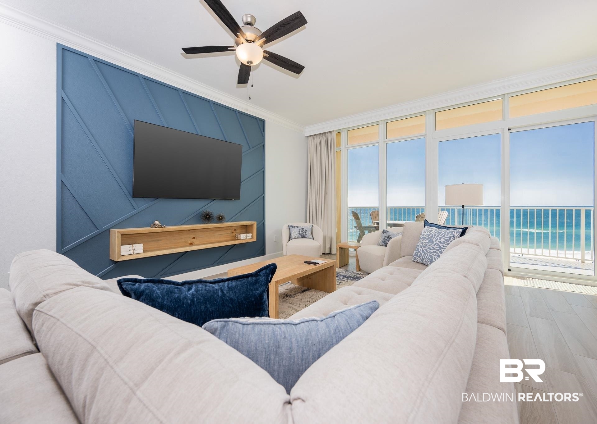 23008 Perdido Beach Boulevard, Unit 506 Orange Beach, AL 36561 - Photo 8 of 48 Living area featuring ornamental molding, a ceiling fan, and wood finished floors
