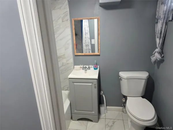 a white toilet sitting next to a bathroom sink