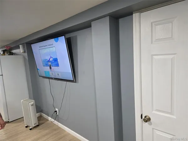 a view of a hallway with wooden floor and closet