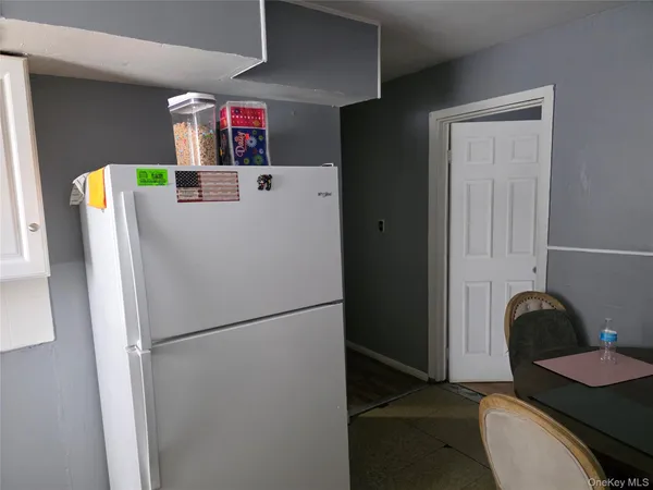 a kitchen with a refrigerator and a table
