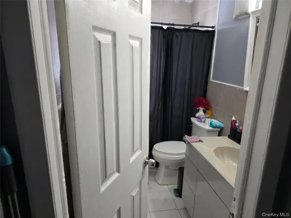 a white toilet sitting next to a bathroom sink