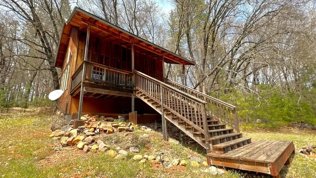 a view of a house with wooden fence